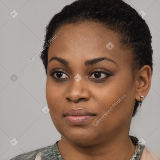 Joyful black young-adult female with short  black hair and brown eyes