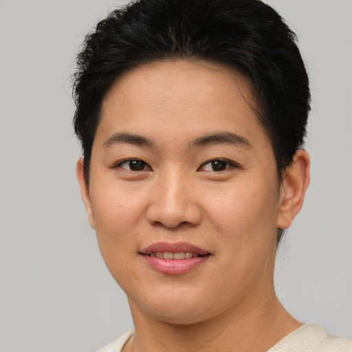 Joyful asian young-adult female with short  brown hair and brown eyes