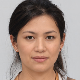 Joyful asian young-adult female with medium  brown hair and brown eyes