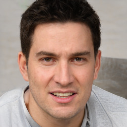 Joyful white adult male with short  brown hair and brown eyes