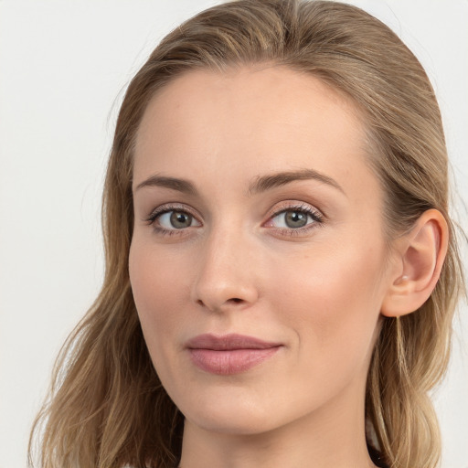 Joyful white young-adult female with long  brown hair and blue eyes