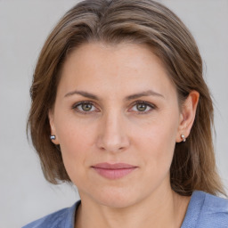 Joyful white young-adult female with medium  brown hair and blue eyes