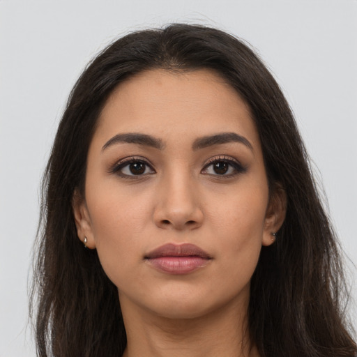 Neutral latino young-adult female with long  brown hair and brown eyes