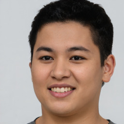 Joyful latino young-adult male with short  brown hair and brown eyes