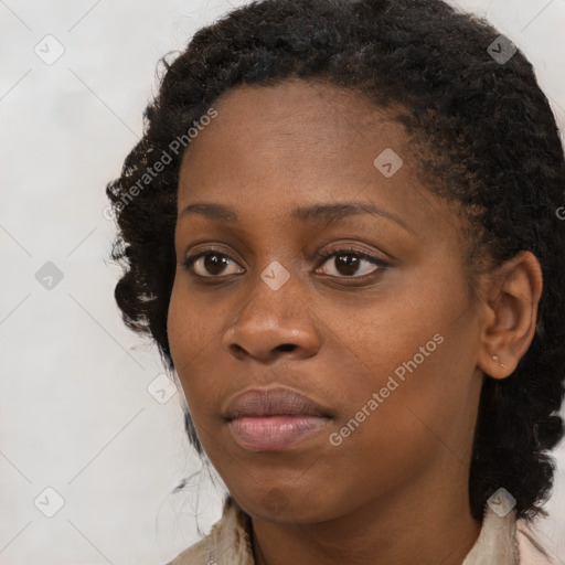 Joyful black young-adult female with long  brown hair and brown eyes