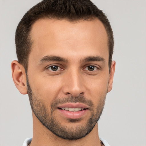 Joyful white young-adult male with short  brown hair and brown eyes