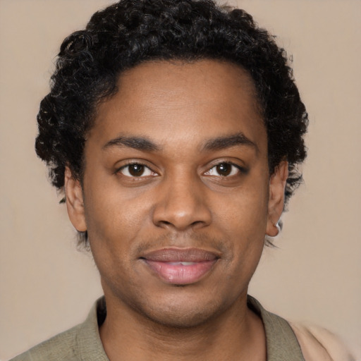 Joyful black young-adult male with short  black hair and brown eyes