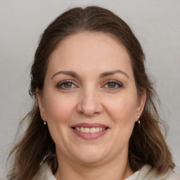 Joyful white adult female with medium  brown hair and grey eyes