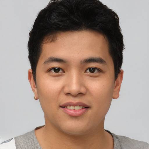 Joyful asian young-adult male with short  black hair and brown eyes
