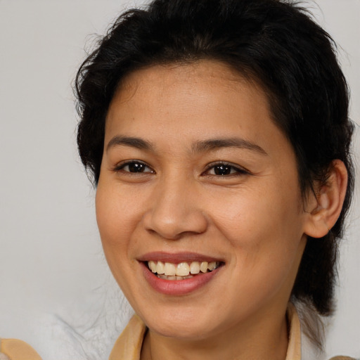 Joyful latino young-adult female with medium  brown hair and brown eyes