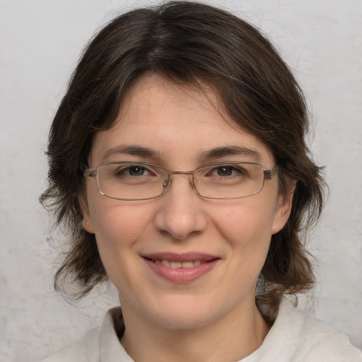 Joyful white adult female with medium  brown hair and brown eyes