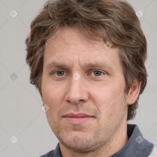 Joyful white adult male with short  brown hair and grey eyes