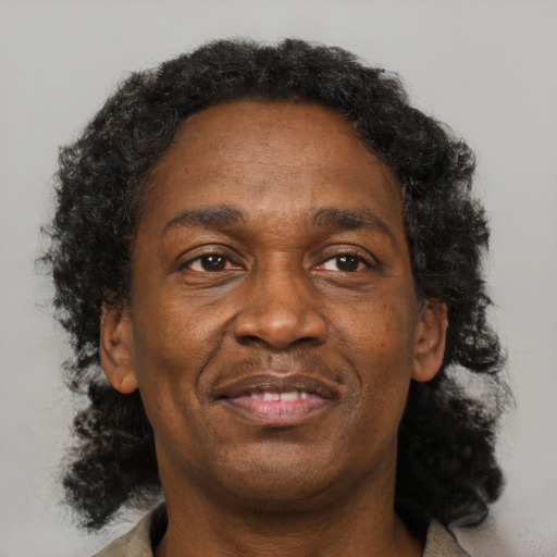 Joyful black adult male with short  brown hair and brown eyes