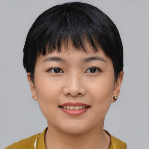 Joyful asian young-adult female with short  black hair and brown eyes