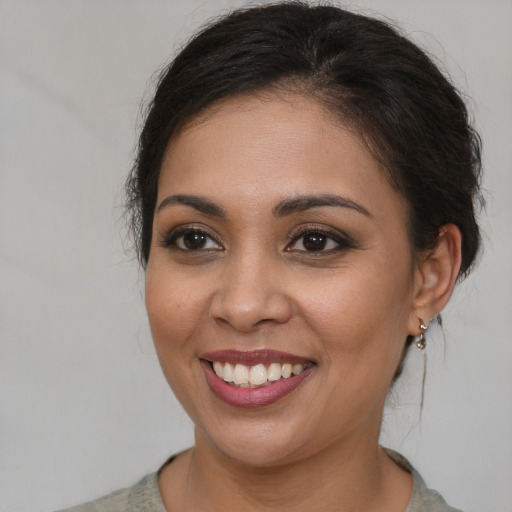 Joyful white young-adult female with medium  brown hair and brown eyes