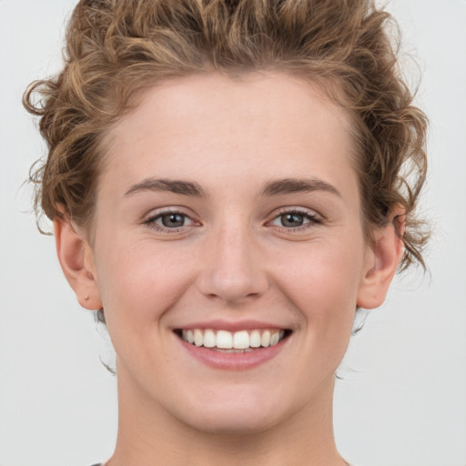 Joyful white young-adult female with medium  brown hair and green eyes