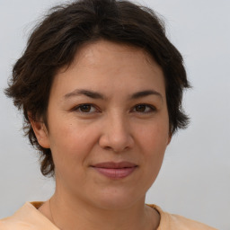 Joyful white adult female with medium  brown hair and brown eyes