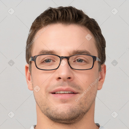 Joyful white young-adult male with short  brown hair and grey eyes