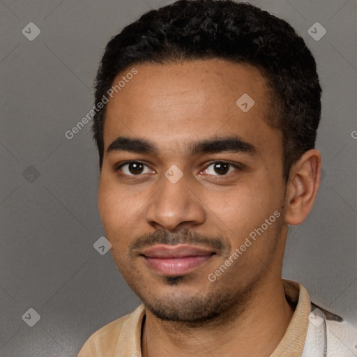 Joyful black young-adult male with short  black hair and brown eyes