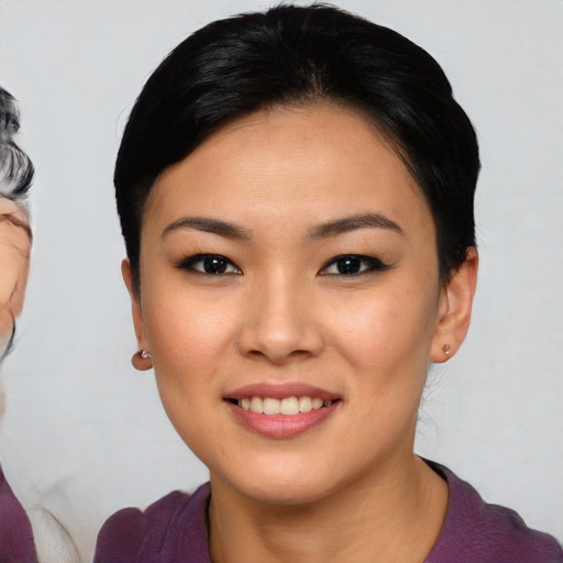 Joyful asian young-adult female with medium  black hair and brown eyes