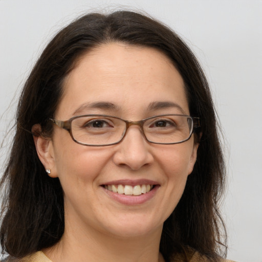 Joyful white adult female with long  brown hair and brown eyes