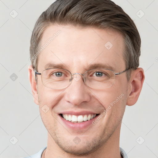 Joyful white adult male with short  brown hair and grey eyes