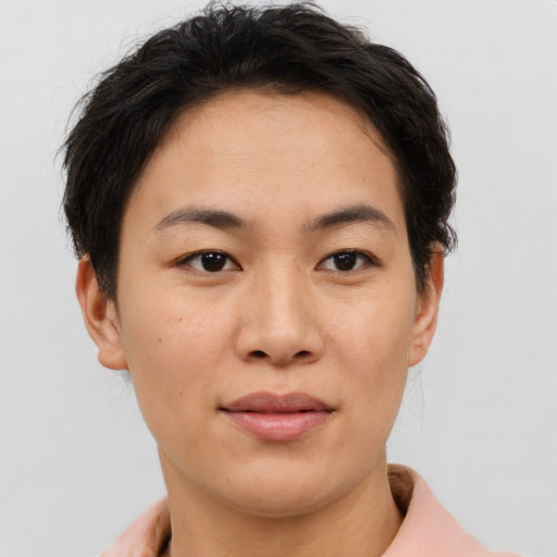 Joyful asian young-adult female with short  brown hair and brown eyes