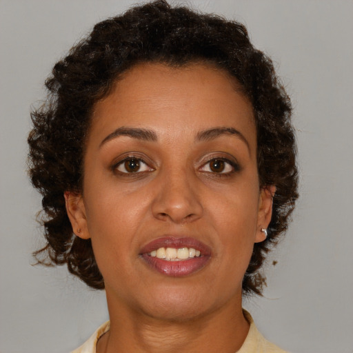 Joyful black young-adult female with medium  brown hair and brown eyes