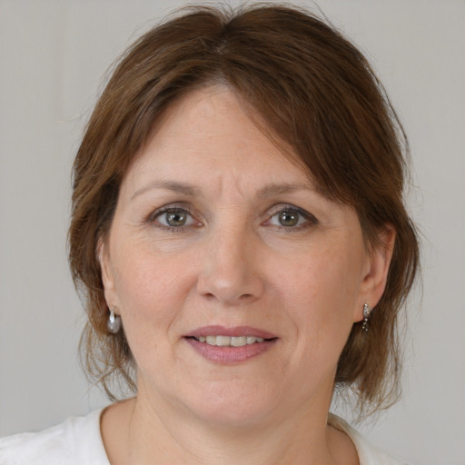 Joyful white adult female with medium  brown hair and brown eyes