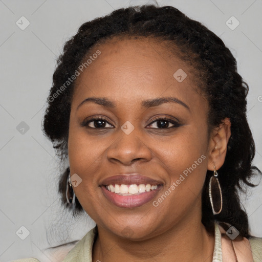 Joyful black young-adult female with long  black hair and brown eyes