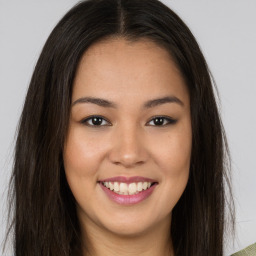 Joyful asian young-adult female with long  brown hair and brown eyes