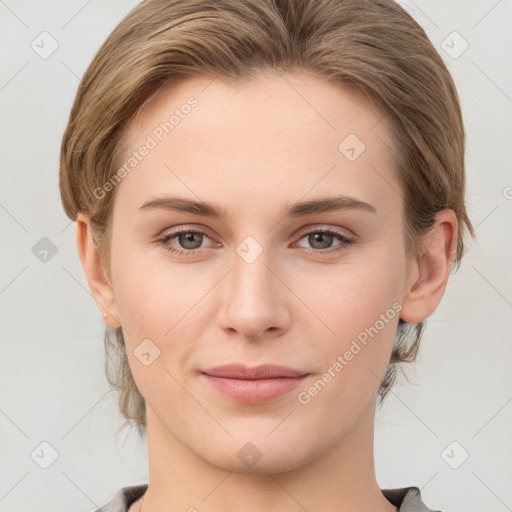 Joyful white young-adult female with medium  brown hair and grey eyes