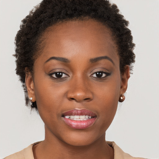 Joyful black young-adult female with short  brown hair and brown eyes