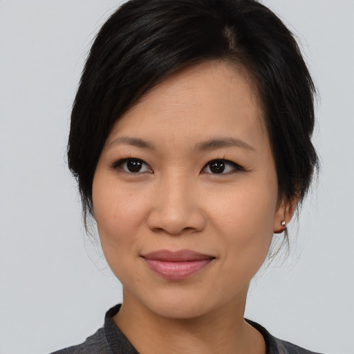 Joyful asian young-adult female with medium  brown hair and brown eyes