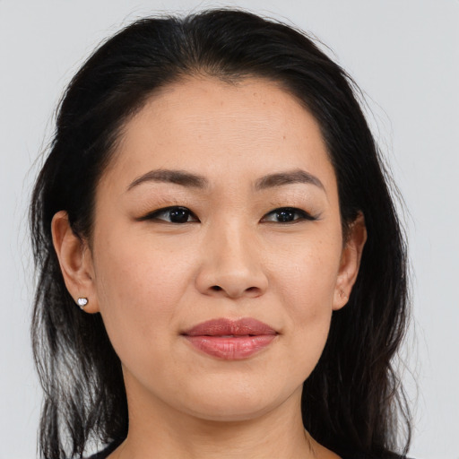 Joyful asian young-adult female with medium  brown hair and brown eyes
