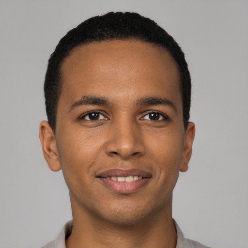 Joyful black young-adult male with short  brown hair and brown eyes
