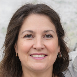 Joyful white adult female with medium  brown hair and grey eyes