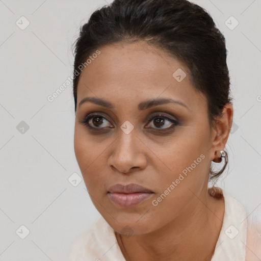 Joyful latino young-adult female with short  brown hair and brown eyes