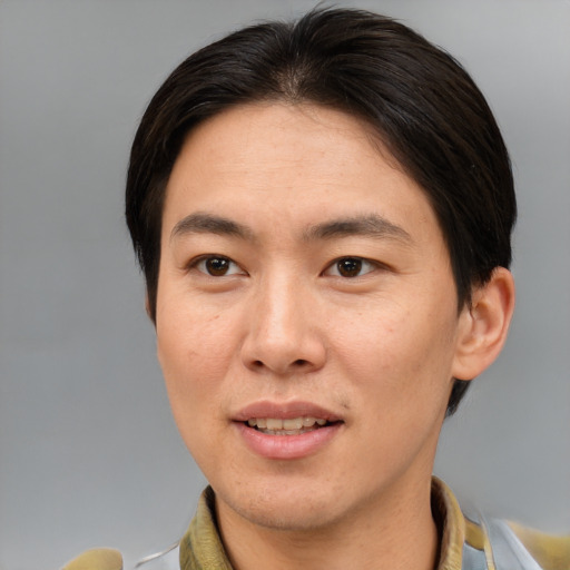 Joyful asian adult male with short  brown hair and brown eyes