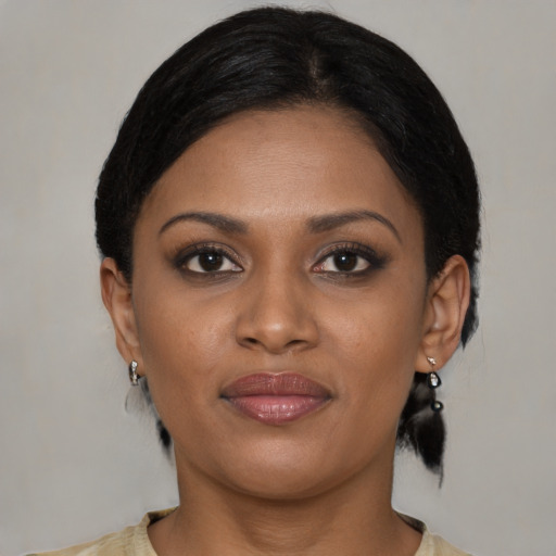 Joyful black young-adult female with medium  black hair and brown eyes