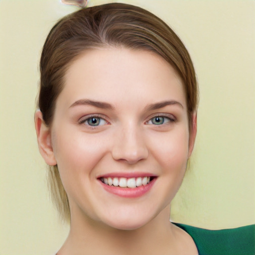 Joyful white young-adult female with medium  brown hair and green eyes