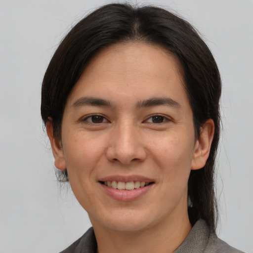 Joyful asian young-adult female with medium  brown hair and brown eyes