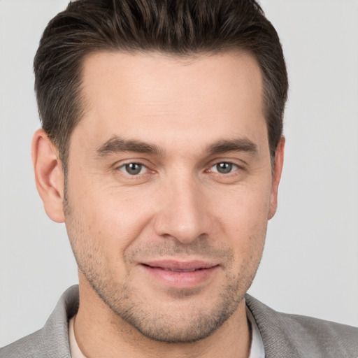 Joyful white young-adult male with short  brown hair and brown eyes