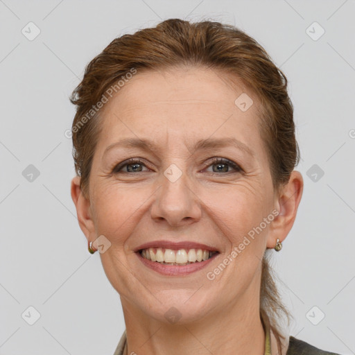 Joyful white adult female with short  brown hair and brown eyes