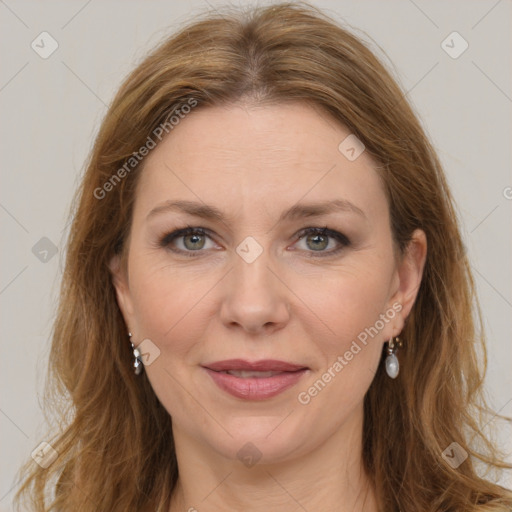 Joyful white adult female with long  brown hair and grey eyes