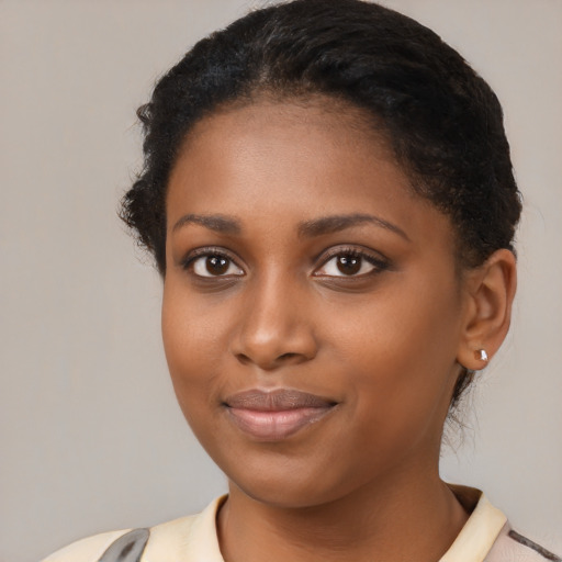 Joyful black young-adult female with medium  black hair and brown eyes
