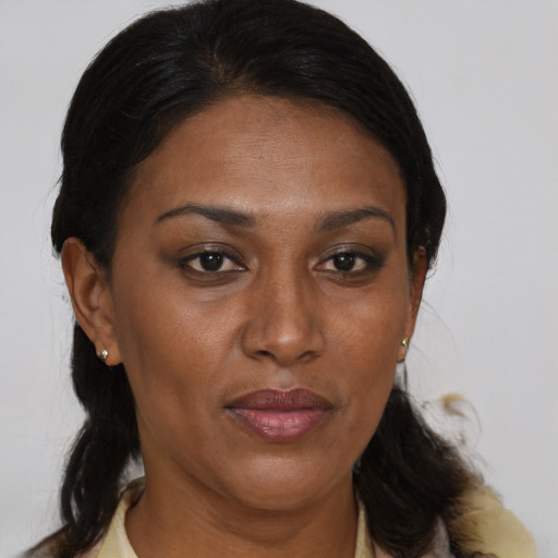 Joyful black adult female with medium  brown hair and brown eyes