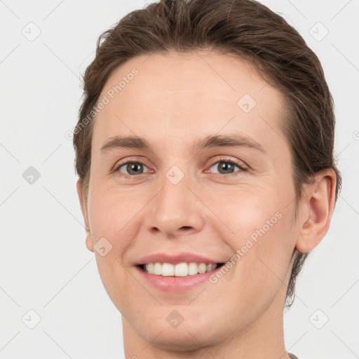 Joyful white young-adult female with short  brown hair and grey eyes