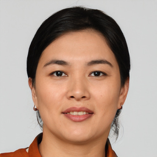 Joyful asian young-adult female with medium  black hair and brown eyes