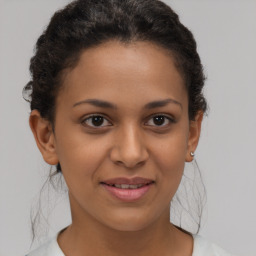 Joyful latino young-adult female with short  brown hair and brown eyes